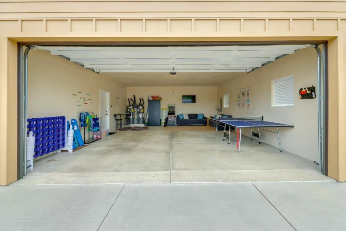 A relaxed recreational space featuring a ping pong table, a comfortable seating area, and storage shelves. This setup is perfect for both active and laid-back game nights, accommodating multiple activities in one room.