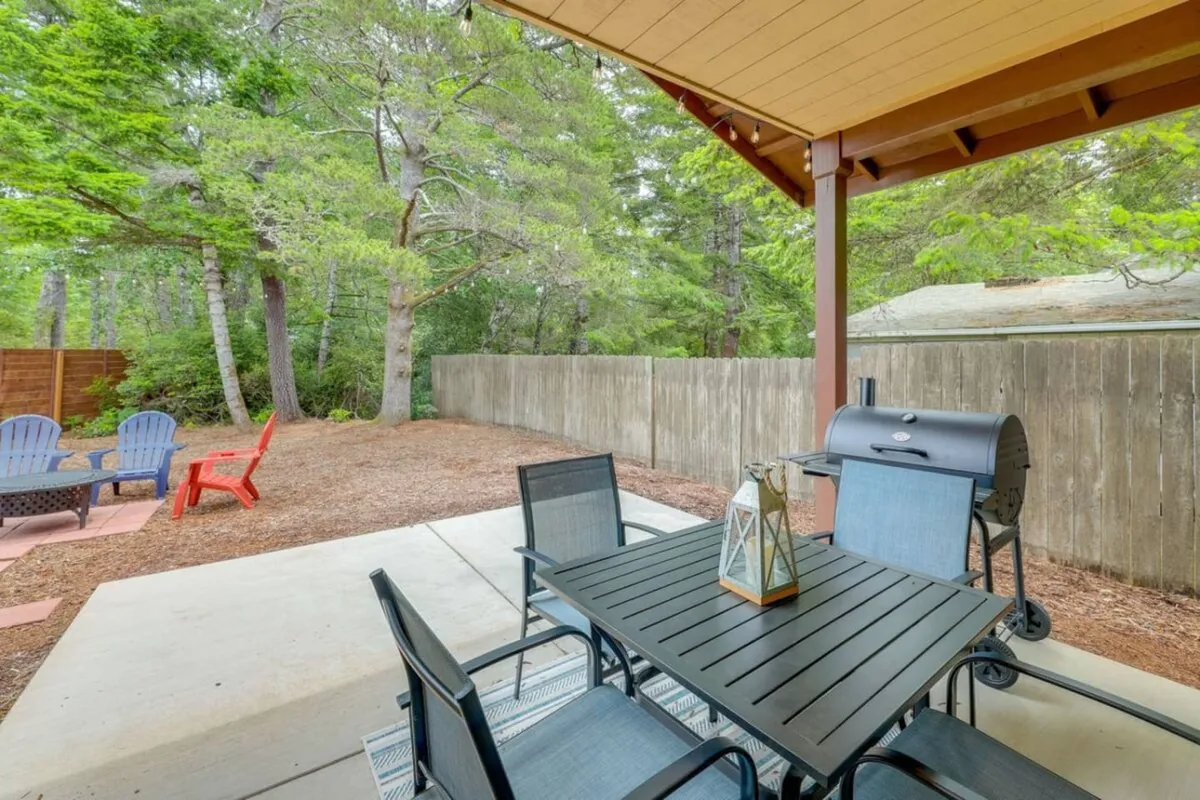 An inviting outdoor dining area featuring a table set for meals, a grill for barbecuing, and adjoining seating spaces. The area is designed for sunset dinners, weekend brunches, or stargazing under the open sky.