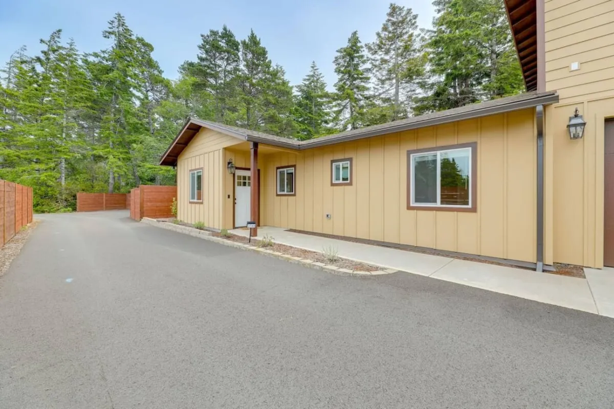 A tranquil front entrance framed by trees and a well-maintained pathway, welcoming guests into the home. The surrounding greenery creates a peaceful environment, reflecting the serene neighborhood close to Old Town Florence.